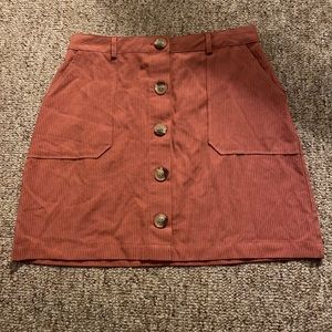 Salmon colored skirt with buttons down the middle